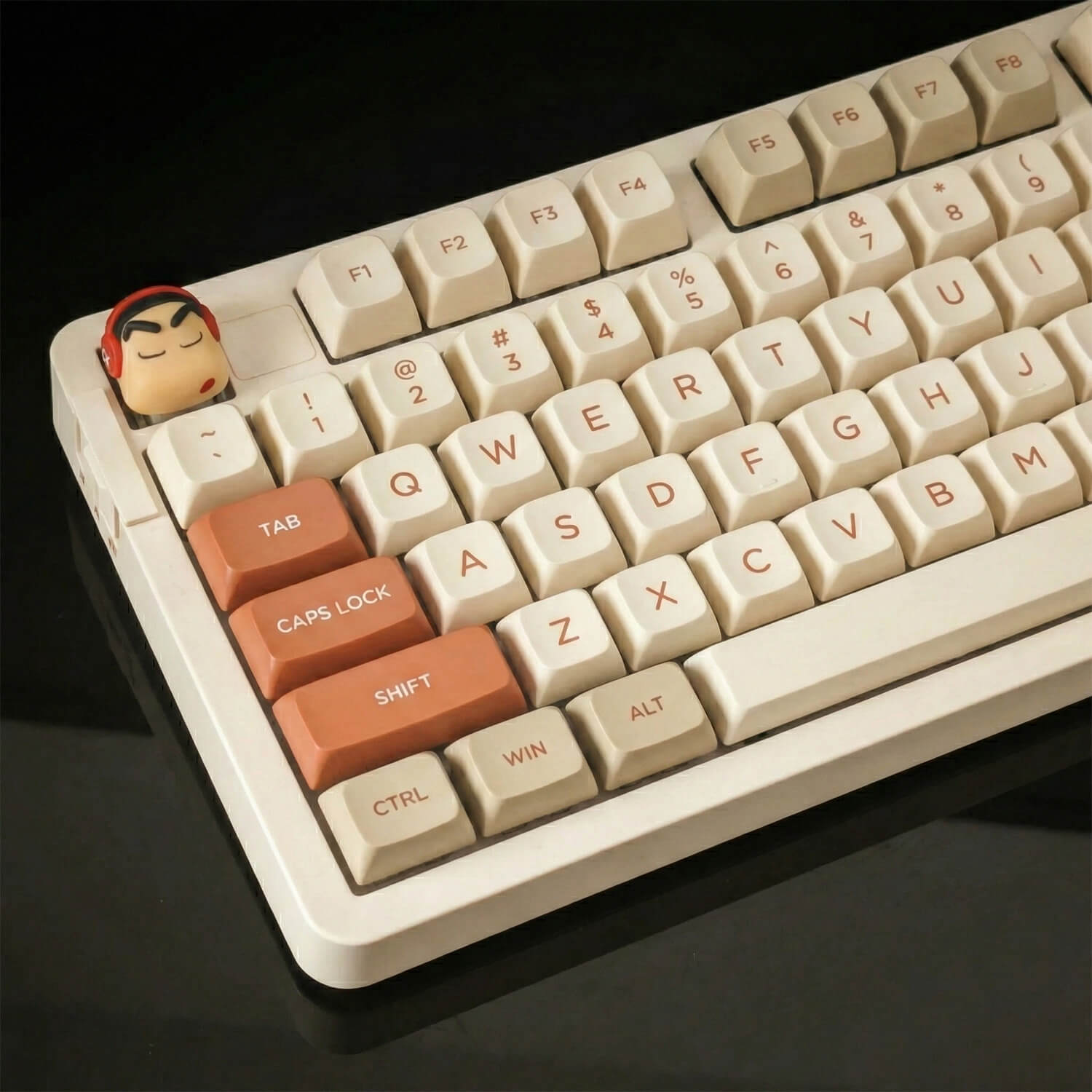 Close-up of a Crayon Shin-chan artisan keycap installed on the ESC key of a mechanical keyboard, shown from a 45-degree left-side angle